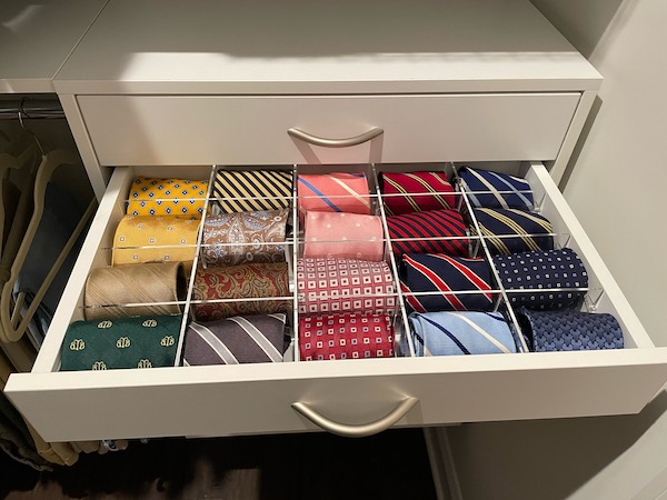 acrylic grid organizer on red mat in desk drawer